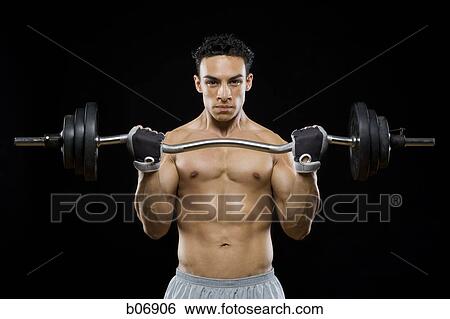 Man working out with barbell View Large Photo Image Stock Photograph - Man working out with barbell. Fotosearch