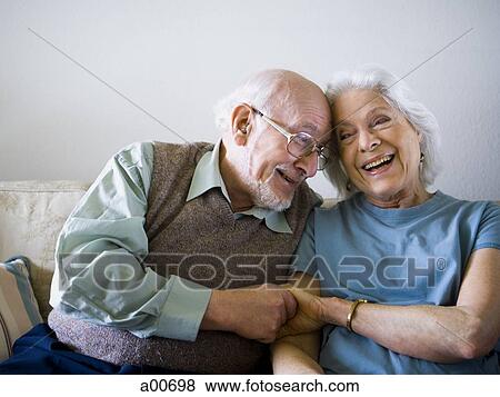 Stock Photo - Mature couple sitting on the couch. Fotosearch