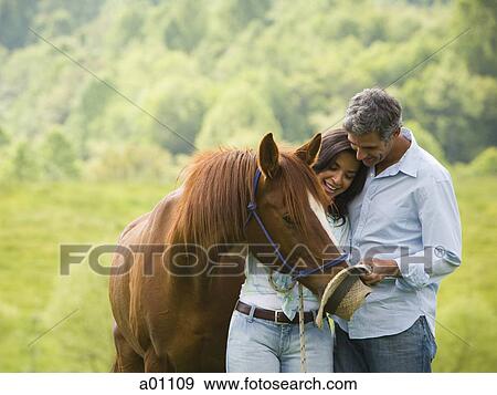 Mature man and a woman with a horse View Large Photo Image Stock Photo - Mature man and a woman with a horse. Fotosearch