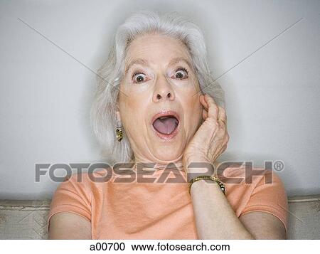 Mature woman sitting on a couch View Large Photo Image Stock Image - Mature woman sitting on a couch. Fotosearch