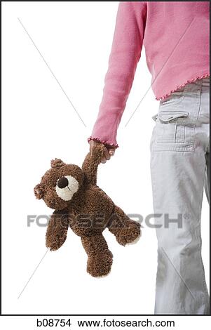 Mid section view of a girl holding a teddy bear View Large Photo Image Picture - Mid section view of a girl holding a teddy bear. Fotosearch