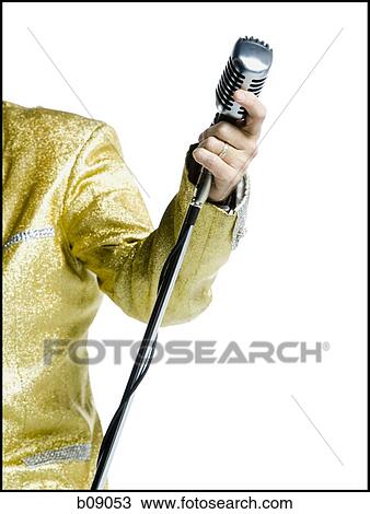 Mid section view of an Elvis impersonator holding a microphone View Large Photo Image Stock Image - Mid section view of an Elvis impersonator holding a microphone. Fotosearch