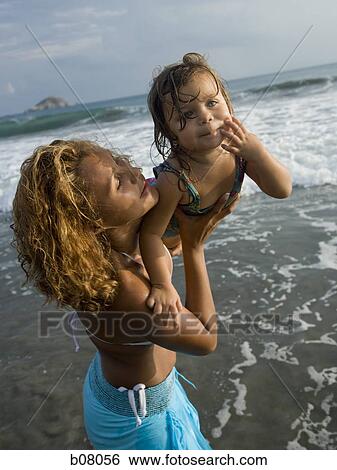 Mother playing with young daughter at beach View Large Photo Image Stock Photograph - Mother playing with young daughter at beach. Fotosearch