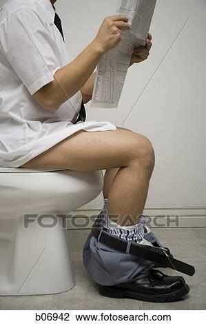 Office worker on toilet reading newspaper View Large Photo Image Stock Image - Office worker on toilet reading newspaper. Fotosearch