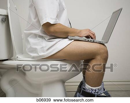 Office worker on toilet using laptop View Large Photo Image Stock Photo - Office worker on toilet using laptop. Fotosearch