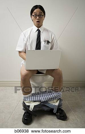 Stock Photo - Office worker on toilet with laptop. Fotosearch