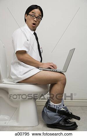 Stock Photography - Office worker on toilet with surprised look. Fotosearch