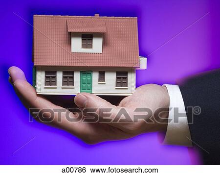 One hand holding model of house View Large Photo Image Stock Photograph - One hand holding model of house. Fotosearch