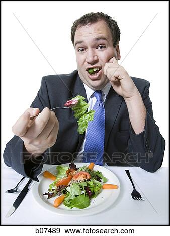 Overweight businessman eating a salad lunch View Large Photo Image Stock Photo - Overweight businessman eating a salad lunch. Fotosearch