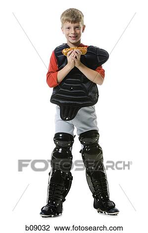 Portrait of a baseball catcher holding a hot dog View Large Photo Image Stock Image - Portrait of a baseball catcher holding a hot dog. Fotosearch