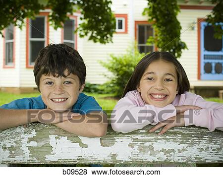 Portrait of a boy and a girl smiling View Large Photo Image Stock Photo - Portrait of a boy and a girl smiling. Fotosearch