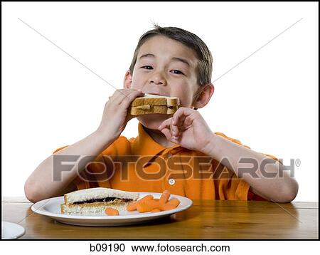 Portrait of a boy eating a sandwich View Large Photo Image Stock Image - Portrait of a boy eating a sandwich. Fotosearch
