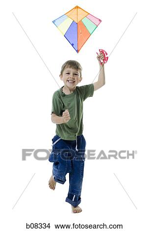 Portrait of a boy flying a kite View Large Photo Image Picture - Portrait of a boy flying a kite. Fotosearch