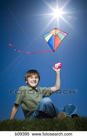 Portrait of a boy flying a kite View Large Photo Image Stock Photography - Portrait of a boy flying a kite. Fotosearch