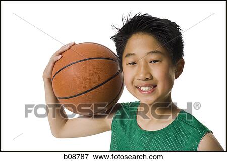 Portrait of a boy holding a basketball and smiling View Large Photo Image Stock Photo - Portrait of a boy holding a basketball and smiling. Fotosearch