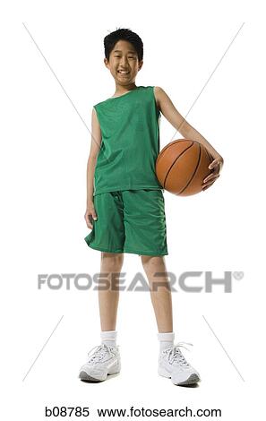 Portrait of a boy holding a basketball and smiling View Large Photo Image Stock Photography - Portrait of a boy holding a basketball and smiling. Fotosearch