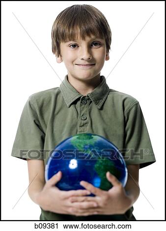 Portrait of a boy holding a globe View Large Photo Image Stock Image - Portrait of a boy holding a globe. Fotosearch