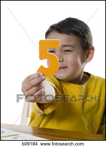 Picture - Portrait of a boy holding a number. Fotosearch