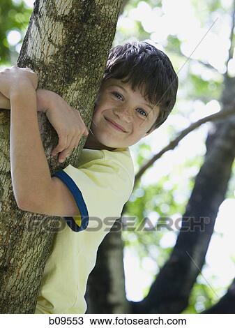 Portrait of a boy holding the branch of a tree View Large Photo Image Stock Image - Portrait of a boy holding the branch of a tree. Fotosearch