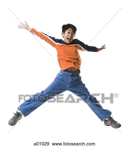 Stock Photo - Portrait of a boy jumping in mid-air. Fotosearch