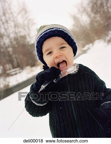 Stock Photo - Portrait of a boy licking an icicle. Fotosearch