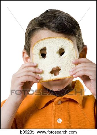 Portrait of a boy looking through a slice of bread View Large Photo Image Stock Photography - Portrait of a boy looking through a slice of bread. Fotosearch