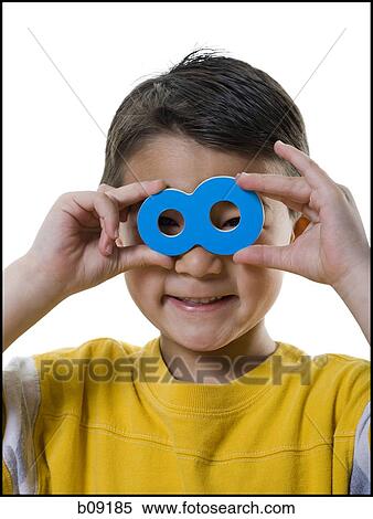 Portrait of a boy looking through the number eight View Large Photo Image Stock Photography - Portrait of a boy looking through the number eight. Fotosearch