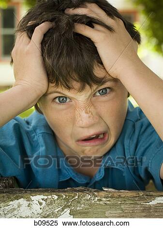 Portrait of a boy making a face with his hands on his head View Large Photo Image Stock Photography - Portrait of a boy making a face with his hands on his head. Fotosearch