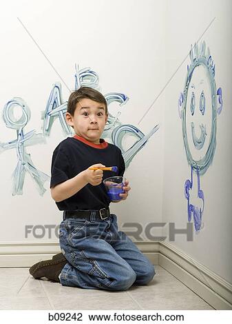 Portrait of a boy painting on a wall View Large Photo Image Stock Image - Portrait of a boy painting on a wall. Fotosearch
