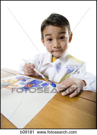 Portrait of a boy painting with a paintbrush View Large Photo Image Stock Image - Portrait of a boy painting with a paintbrush. Fotosearch