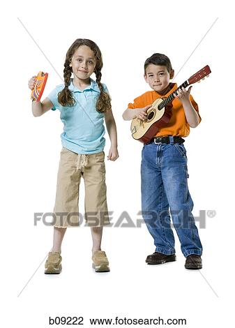 Portrait of a boy playing the guitar with a girl standing beside him View Large Photo Image Stock Image - Portrait of a boy playing the guitar with a girl standing beside him. Fotosearch