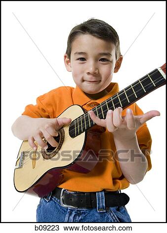 Portrait of a boy playing the guitar View Large Photo Image Stock Image - Portrait of a boy playing the guitar. Fotosearch