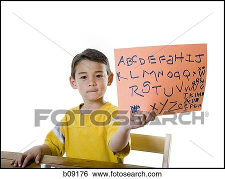 Portrait of a boy showing alphabets on a blank sign View Large Photo Image Stock Photograph - Portrait of a boy showing alphabets on a blank sign. Fotosearch