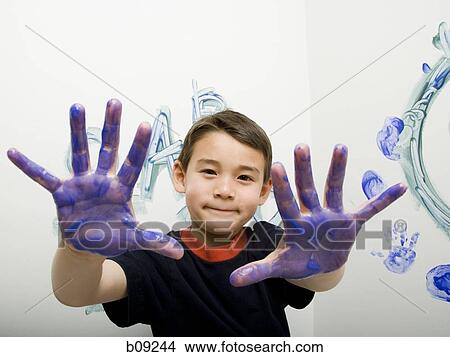 Portrait of a boy showing his painted hand View Large Photo Image Picture - Portrait of a boy showing his painted hand. Fotosearch