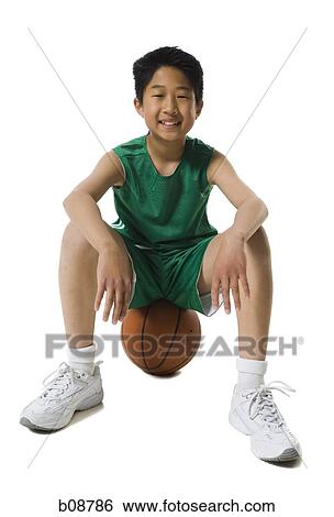 Portrait of a boy sitting on a basketball and smiling View Large Photo Image Stock Photograph - Portrait of a boy sitting on a basketball and smiling. Fotosearch
