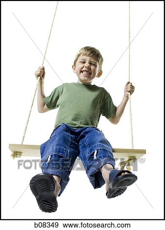 Portrait of a boy sitting on a swing View Large Photo Image Stock Photo - Portrait of a boy sitting on a swing. Fotosearch