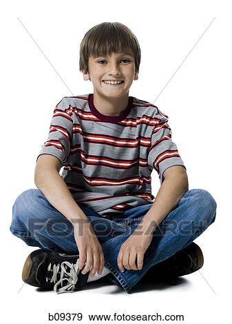 Portrait of a boy sitting with his legs crossed View Large Photo Image Stock Photo - Portrait of a boy sitting with his legs crossed. Fotosearch