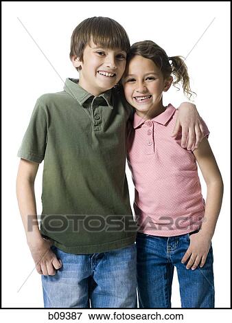 Stock Photo - Portrait of a boy standing with his arm around his sister. Fotosearch
