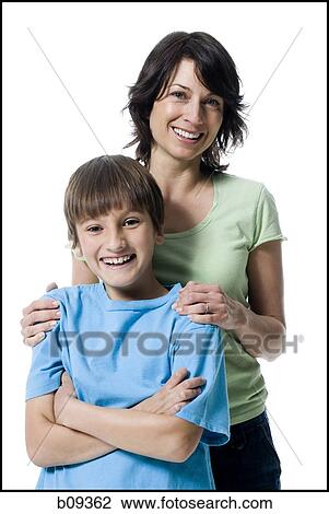 Portrait of a boy standing with his mother View Large Photo Image Stock Image - Portrait of a boy standing with his mother. Fotosearch