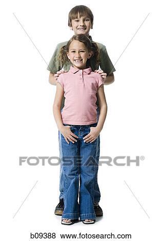 Portrait of a boy standing with his sister View Large Photo Image Stock Photo - Portrait of a boy standing with his sister. Fotosearch