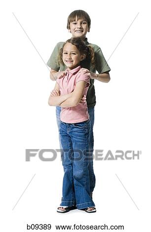 Portrait of a boy standing with his sister View Large Photo Image Stock Photo - Portrait of a boy standing with his sister. Fotosearch