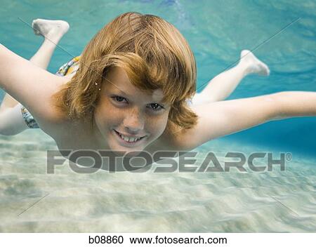 Portrait of a boy swimming underwater View Large Photo Image Stock Image - Portrait of a boy swimming underwater. Fotosearch