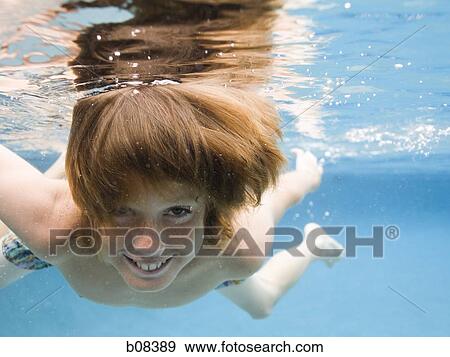 Portrait of a boy swimming underwater View Large Photo Image Stock Photo - Portrait of a boy swimming underwater. Fotosearch