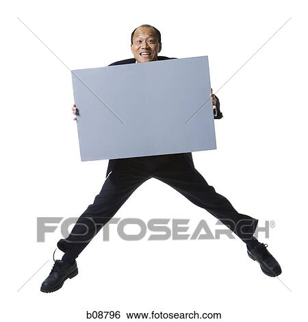 Portrait of a businessman holding a blank sign and jumping View Large Photo Image Stock Photograph - Portrait of a businessman holding a blank sign and jumping. Fotosearch