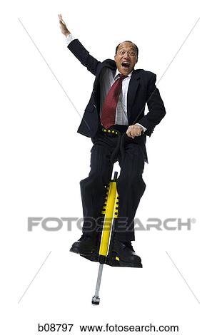 Portrait of a businessman on a pogo stick View Large Photo Image Stock Photo - Portrait of a businessman on a pogo stick. Fotosearch