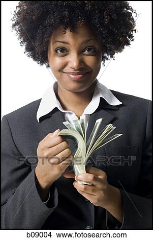 Portrait of a businesswoman holding paper currency View Large Photo Image Picture - Portrait of a businesswoman holding paper currency. Fotosearch