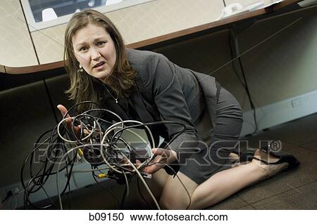 Portrait of a businesswoman holding tangled wires View Large Photo Image Stock Image - Portrait of a businesswoman holding tangled wires. Fotosearch