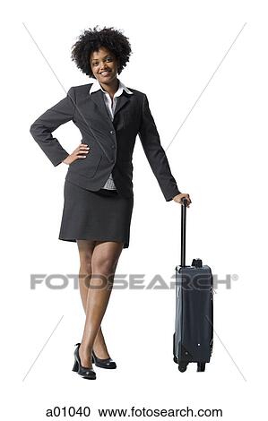 Portrait of a businesswoman standing with luggage View Large Photo Image Stock Image - Portrait of a businesswoman standing with luggage. Fotosearch