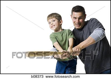 Stock Image - Portrait of a father teaching his son how to swing a baseball bat. Fotosearch