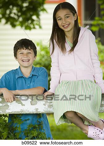 Portrait of a girl and a boy smiling View Large Photo Image Stock Image - Portrait of a girl and a boy smiling. Fotosearch